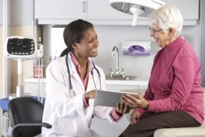 Doctor Discussing Records With Senior Female Patient